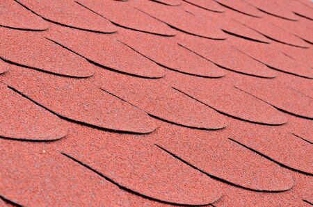 Close up detail of red shingles on a roofの写真素材