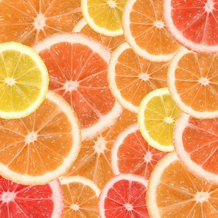 A slices of lemon, orange and grapefruit texture backgroundの写真素材