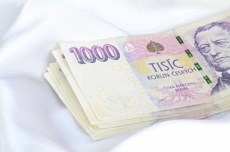 Czech banknotes thousand money currency isolated on white satin fabric