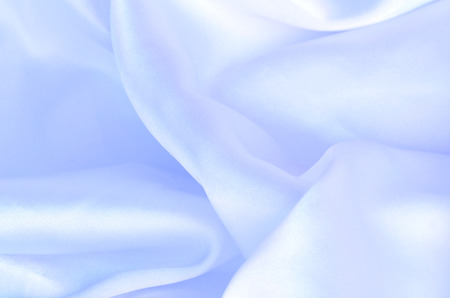 Smooth elegant blue silk, satin fabric background texture patternの写真素材