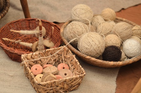 Old medieval thread for weaving loom in basketの写真素材