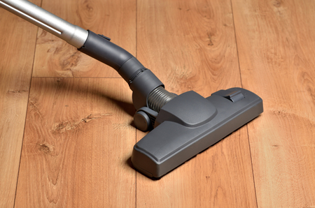 Vacuum cleaner on floating floor - close-up of noozleの写真素材
