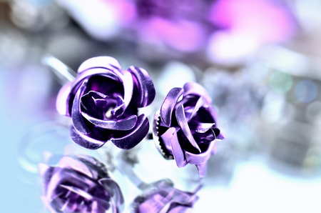 Purple earrings in the shape of a roseの写真素材