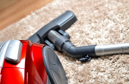 Vacuum cleaner on hairy carpet - close-up of head noozle and modern hooverの写真素材
