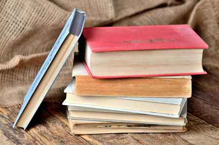 Old, vintage books on a rustic wooden tableの写真素材
