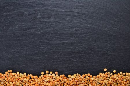 Heap of dried peas downside on slate slab. Frame picture from above with copyspace.の写真素材