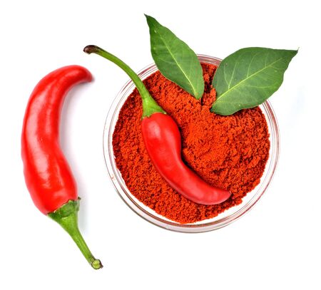 Chili peppers, spice chili powder and plant leaves isolated on white background.