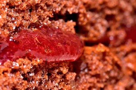 Texture of baked gingerbreads with strawberry jam. Macro detail.