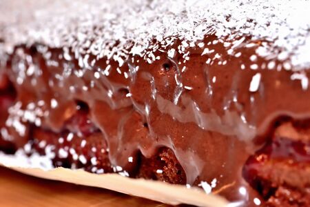 Texture of baked gingerbreads with strawberry jam, sprinkled coconut and chocolate cream. Macro detail.の写真素材
