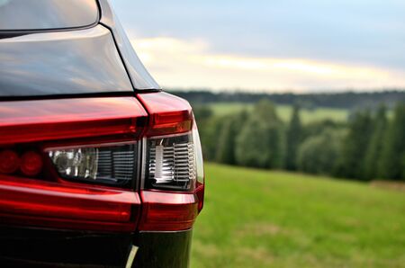Rear brake lights of modern black SUV crossover car vehicle in nature.の写真素材