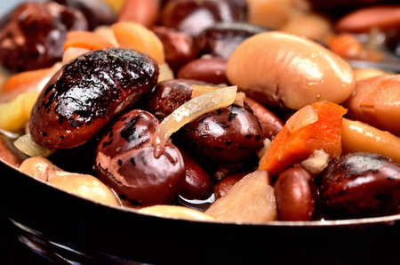 Close-up of bean soup with large beans in an old enamel pot