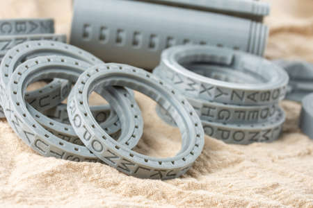 Plastic parts printed on a 3D printer, round letters rings.