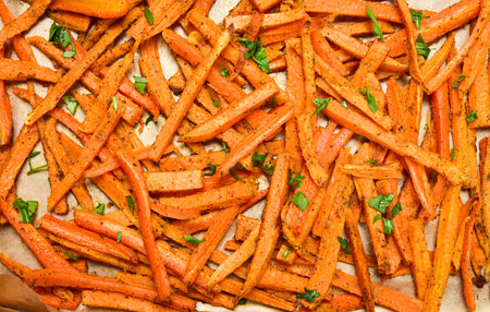 Close-up of homemade sweet potatoes chips on baking paper. View from above. Vegetarian - vegan...
