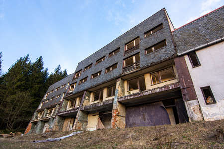 Old abandoned socialist communist hotel building without windows and doors in former Czechoslovakiaの写真素材