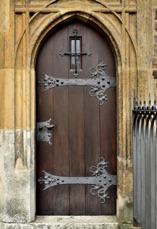Wooden gothic door with ornamental ironwork. Cathedral of St. Peter and Paul in Brno. Front view.の写真素材