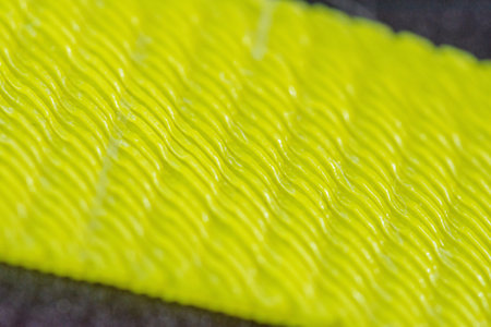 Detail of the structure of the first layer of plastic printing on a 3D printer. Yellow plastic part, macro detail of individual plastic fibersの写真素材