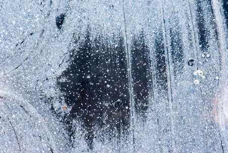 Abstract patterns in a frozen puddle.の写真素材