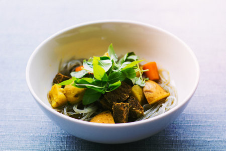 Bowl of Vietnamese noodles with meat and vegetables.