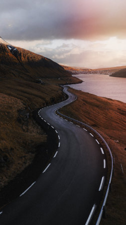 Road background, scenic freeway by the lake on Faroe Islands