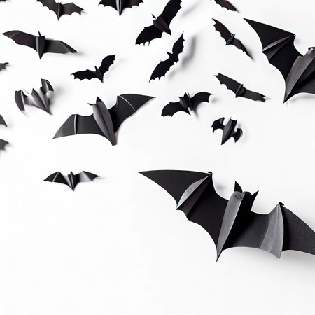 halloween and decoration concept - black paper bats flying over white backgroundの素材