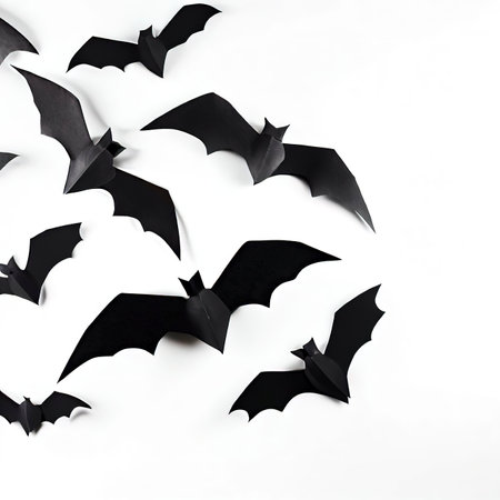 halloween and decoration concept - black paper bats flying over white backgroundの素材