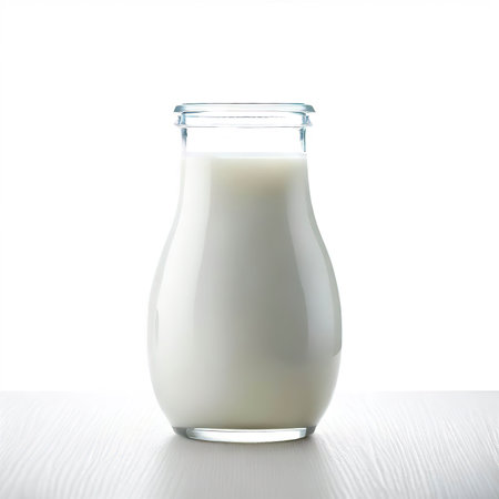 milk on a table isolated on white backgroundの素材
