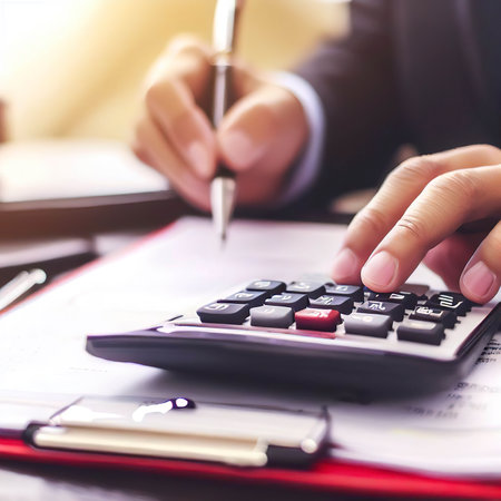 Tax payment concept. Business man using calculator for calculating taxesの素材