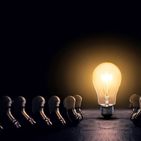 One of Lightbulb glowing among shutdown light bulb in dark area with copy space for creative thinking , problem solving solution and outstanding conceptの素材