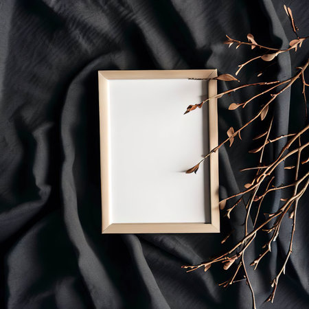 Mockup blank photo frame and branches on dark cotton fabric top and vertical viewの素材