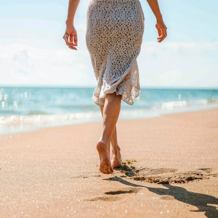 Female legs on the beach closeupの素材