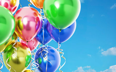 Multicolored balloons on a blue sky background. Concept of celebration, greeting banner, Birthday partyの素材