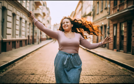 Beautiful plus size woman walking in the city with long curly hairの素材