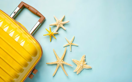 Yellow suitcase starfishes on a white background. Top view, flat lay.