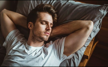 Attractive young man sleeping in bedの素材