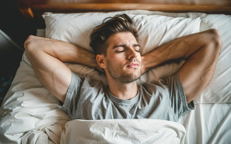 Attractive young man sleeping in bedの素材