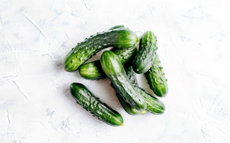 Fresh cucumbers on a white background. Top view, flat layの素材