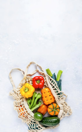 Fresh vegetables in a cloth bag on a white background. Top view, flat layの素材