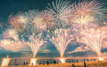 Fireworks with silhouettes of people in a holiday events. New Year fireworks on the beachの素材