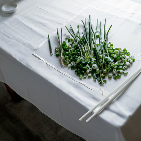 Chopped green onions on a white tableの素材