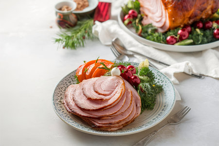 Christmas spiral ham served on a plate for holiday dinner with vegetables on the sideの素材