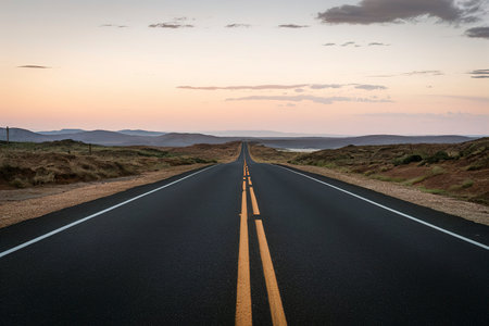 asphalt road stretching into the horizonの素材