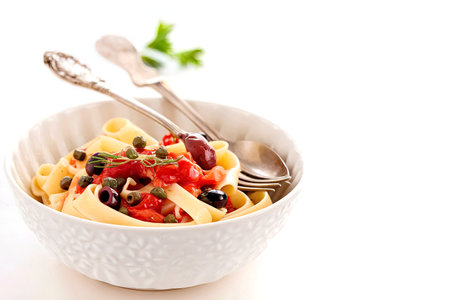 Celery root pasta with tomatoes, olives and capersの写真素材
