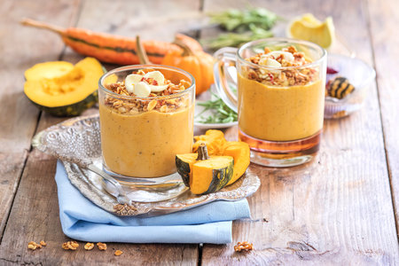 Pumpkin smoothie topped with pumpkin granola for breakfastの写真素材
