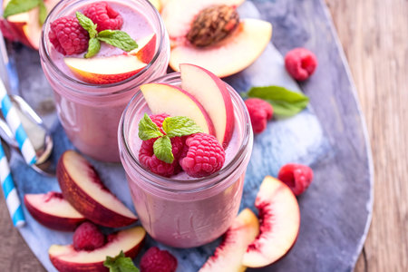 Raspberry and white peach smoothie in mason jarsの写真素材