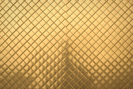 A repeating geometric pattern of raised golden diamonds creating a textured, luxurious, and abstract background.の写真素材