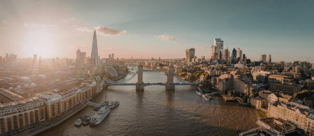The image depicts a panoramic view of London cityscape with a river flowing through it, featuring a...