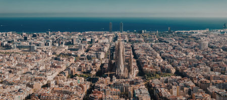 An aerial view of Barcelona cityscape with a prominent cathedral in the center and sea in the...