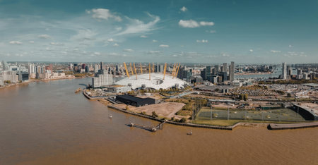 An aerial view of a city situated by a large body of water, showcasing a mix of industrial and urban...
