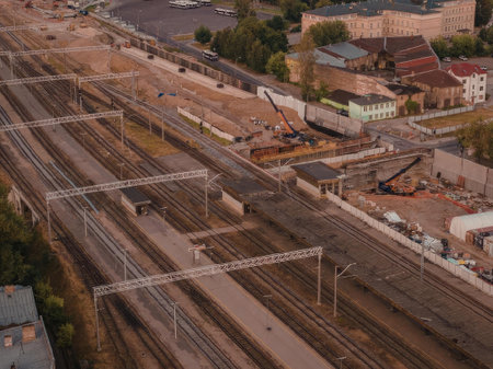 An aerial view of a train yard with multiple tracks and surrounding buildings
