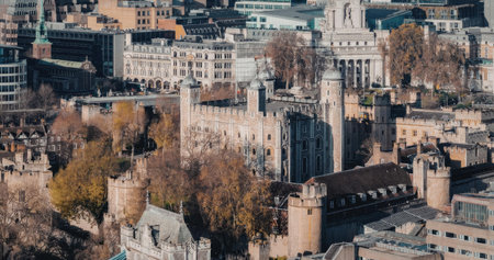 The image shows an aerial view of the Tower of London, a historic fortress situated in the heart of...